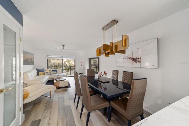 dining room with light hardwood / wood-style flooring and ceiling fan