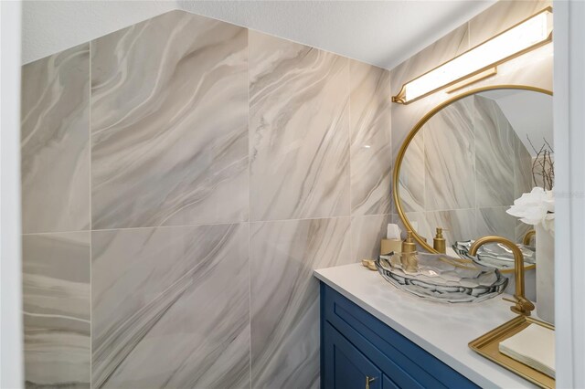 bathroom with tile walls and vanity