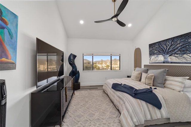 bedroom featuring light hardwood / wood-style flooring, high vaulted ceiling, and ceiling fan