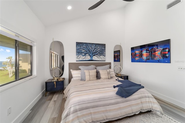 bedroom featuring high vaulted ceiling, ceiling fan, and hardwood / wood-style floors