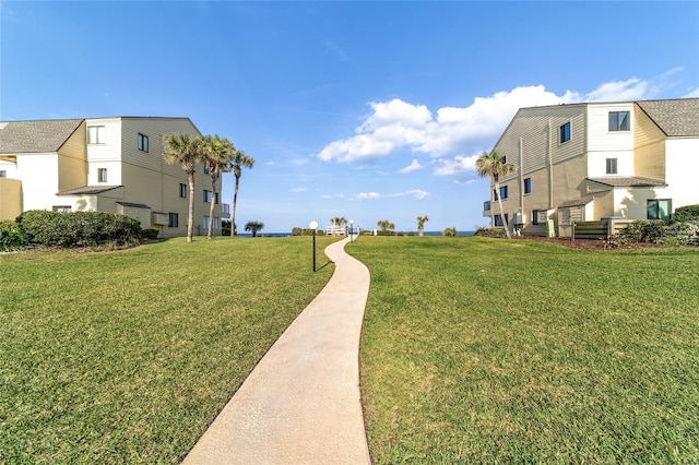 view of property's community featuring a lawn