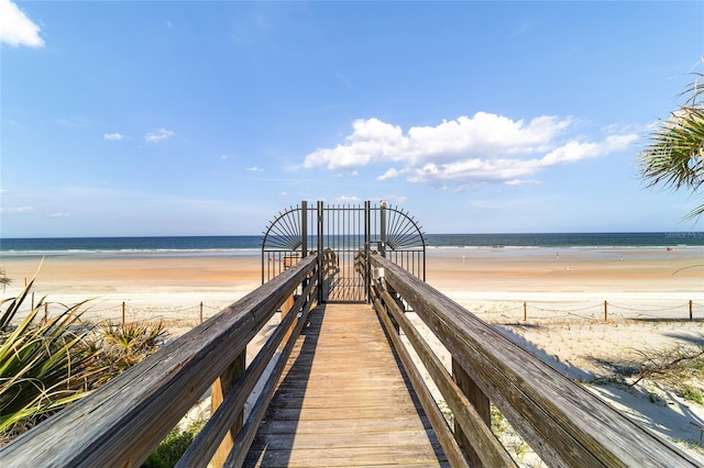 view of property's community with a water view and a view of the beach