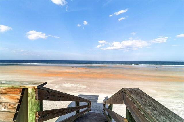 surrounding community featuring a water view and a view of the beach