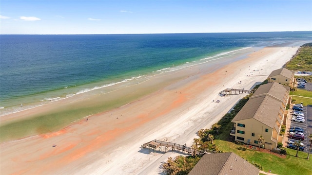 birds eye view of property featuring a view of the beach and a water view