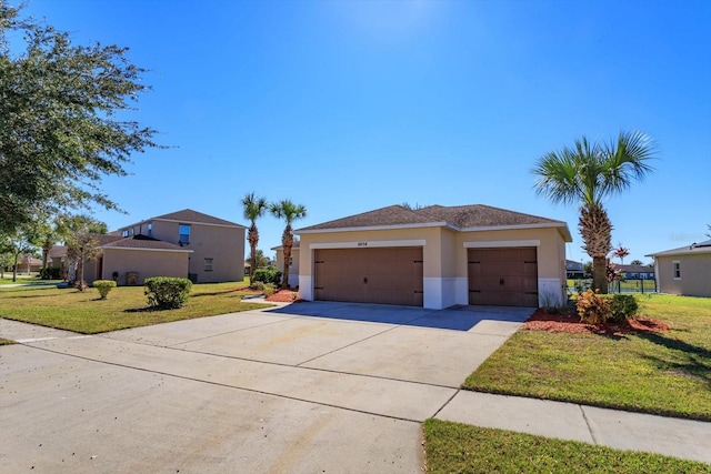 view of front of property featuring a garage and a front lawn