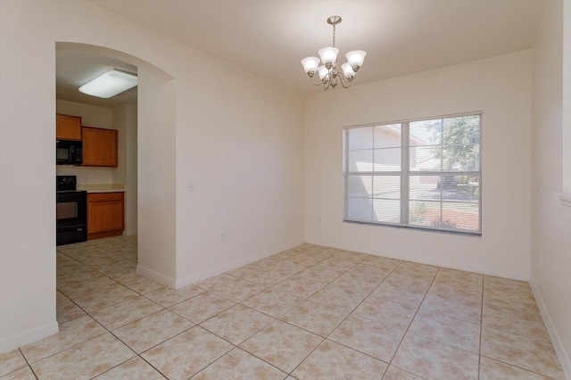 tiled empty room with a chandelier