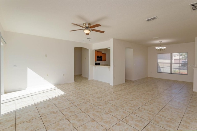 unfurnished room featuring ceiling fan with notable chandelier and light tile patterned flooring