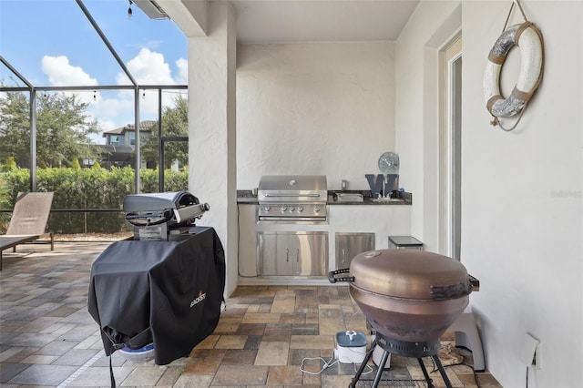 view of patio / terrace with grilling area, glass enclosure, and area for grilling