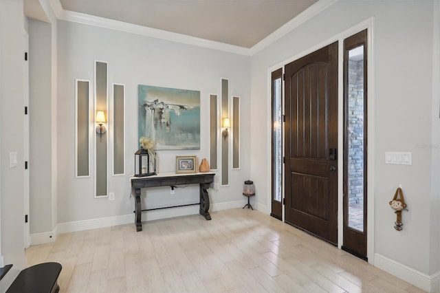 foyer with light hardwood / wood-style floors and crown molding