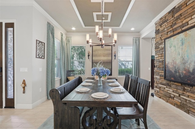 dining area featuring crown molding, light wood-type flooring, and a chandelier