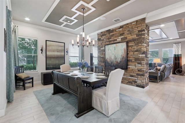 dining room with crown molding and an inviting chandelier