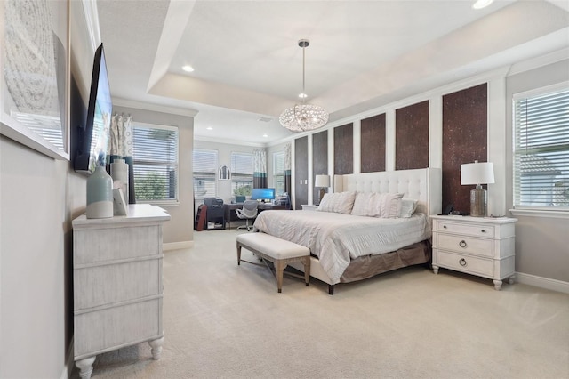 bedroom featuring light carpet, a chandelier, and a tray ceiling