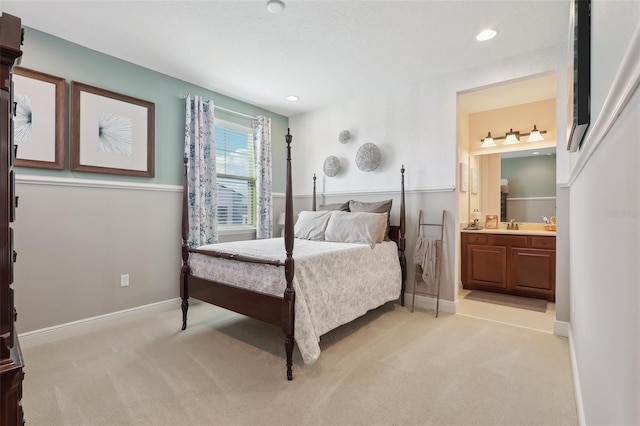 carpeted bedroom with ensuite bath