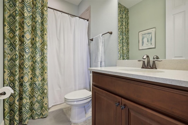 bathroom featuring vanity, toilet, and tile patterned flooring