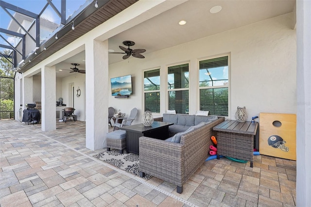 view of patio / terrace featuring outdoor lounge area, ceiling fan, and a lanai