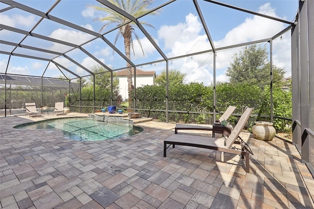 view of swimming pool with a lanai, a hot tub, and a patio