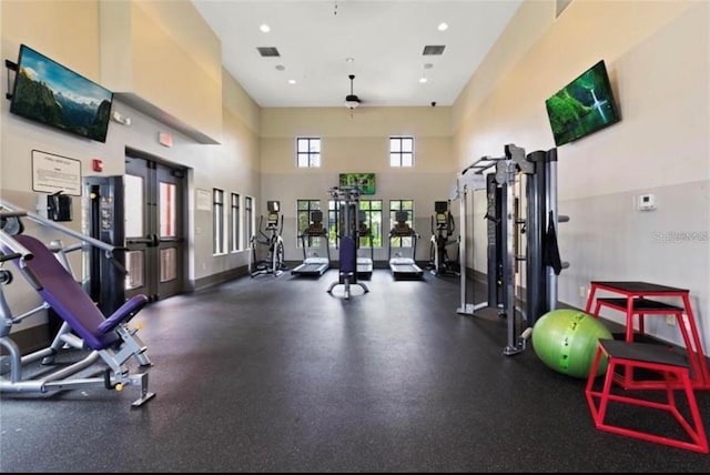 workout area with a high ceiling