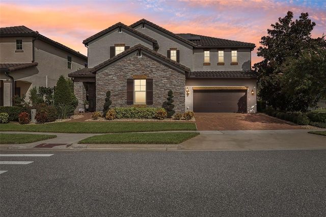 view of front of home featuring a garage and a lawn