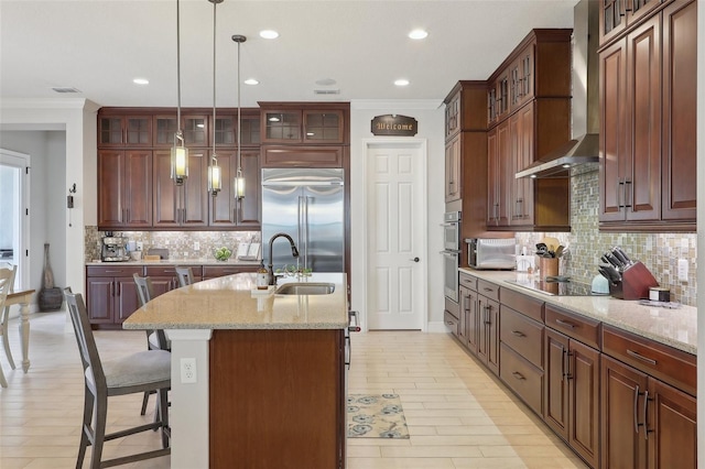 kitchen featuring light hardwood / wood-style flooring, tasteful backsplash, crown molding, stainless steel appliances, and wall chimney range hood