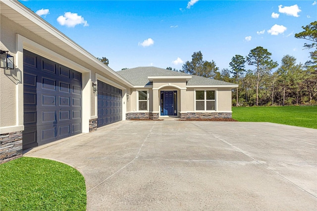 view of front of home with a front yard and a garage