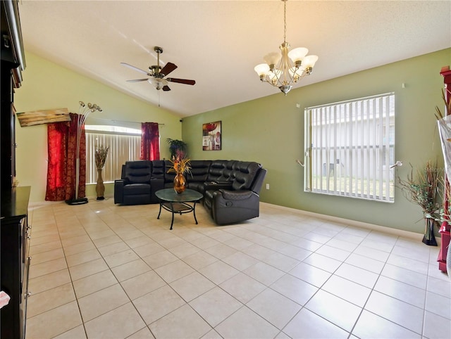 living room featuring lofted ceiling, ceiling fan with notable chandelier, and light tile patterned floors