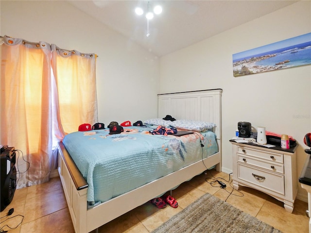 bedroom featuring vaulted ceiling and light tile patterned floors