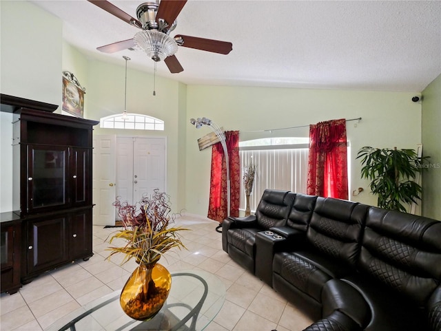 living room with light tile patterned floors, vaulted ceiling, and ceiling fan