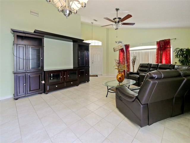 living room with high vaulted ceiling, ceiling fan with notable chandelier, and light tile patterned floors