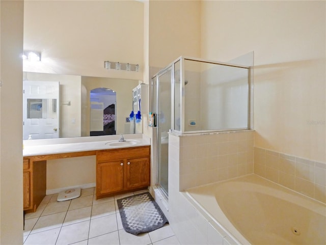 bathroom with vanity, tile patterned flooring, and shower with separate bathtub