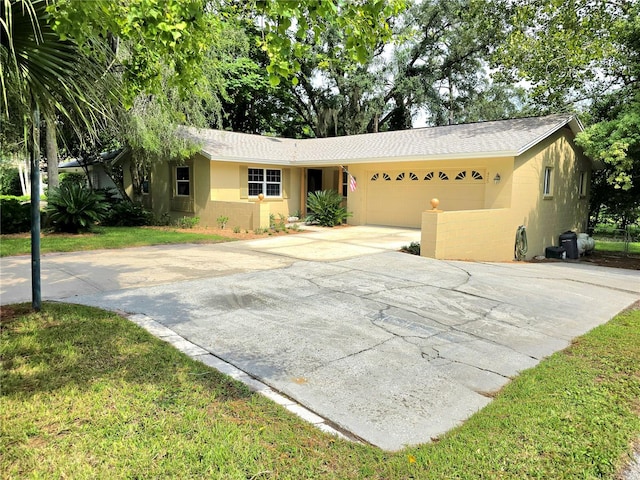 ranch-style home with a front yard and a garage