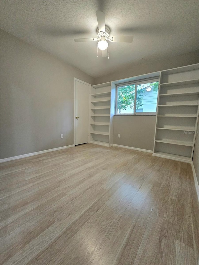 unfurnished bedroom with ceiling fan, light hardwood / wood-style floors, and a textured ceiling