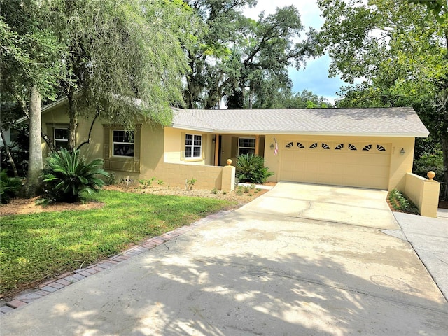 ranch-style home with a garage and a front lawn