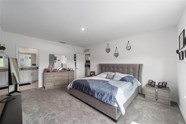 carpeted bedroom with ensuite bath