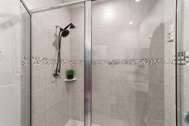 bathroom with a shower with door