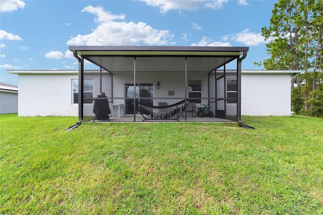 781 Marion Oaks Trl, Ocala, FL 34473 - back of house with a lawn, a sunroom, a patio area, and stucco siding