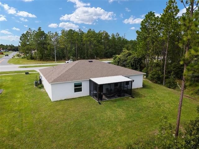 781 Marion Oaks Trl, Ocala, FL 34473 - rear view of house featuring a sunroom, stucco siding, and a lawn