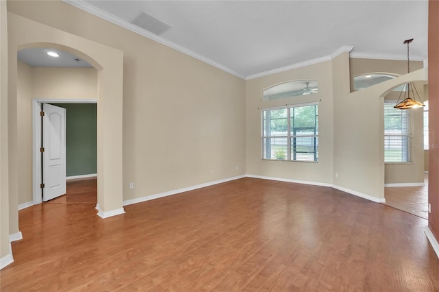 spare room featuring crown molding, hardwood / wood-style floors, and ceiling fan