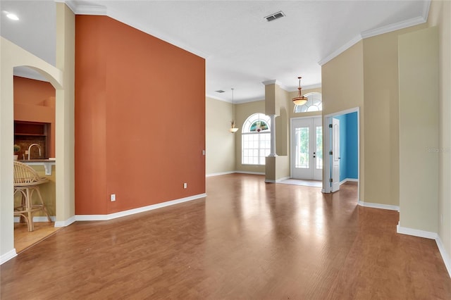 spare room with hardwood / wood-style flooring and ornamental molding