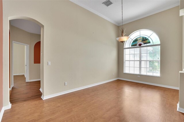 unfurnished room with crown molding and wood-type flooring