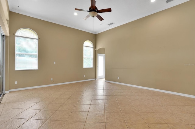 unfurnished room with ceiling fan, light tile patterned floors, and plenty of natural light