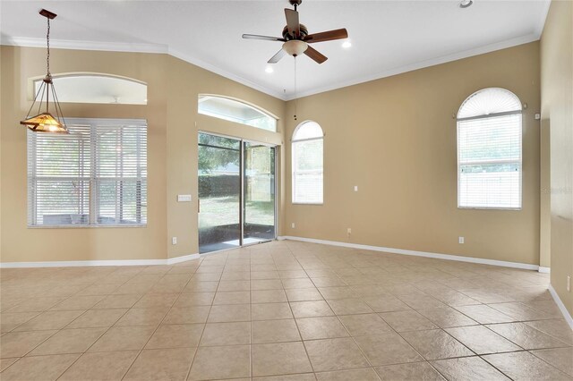 tiled empty room featuring crown molding and ceiling fan