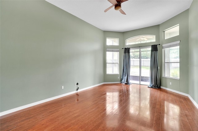 empty room with hardwood / wood-style flooring and ceiling fan