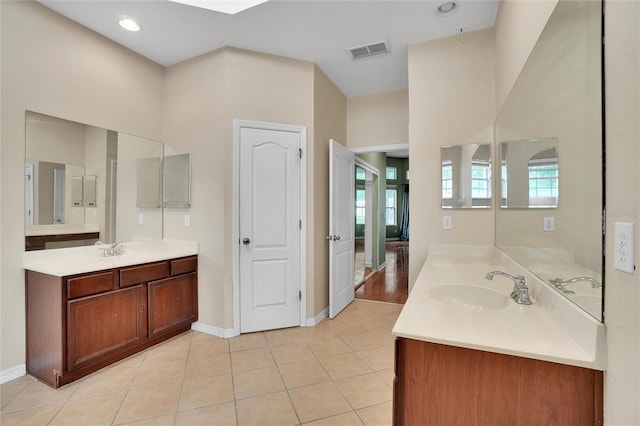 bathroom with dual vanity and hardwood / wood-style flooring