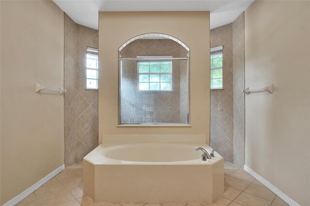 bathroom featuring tile patterned flooring and a bathtub