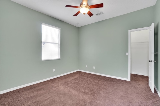 carpeted empty room featuring ceiling fan