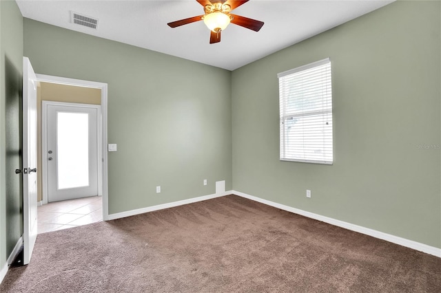 carpeted empty room featuring ceiling fan