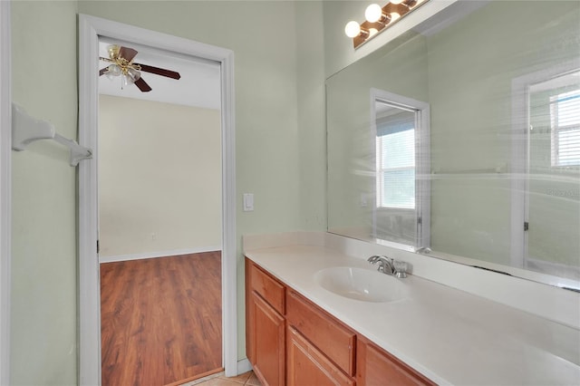 bathroom with plenty of natural light, vanity, ceiling fan, and wood-type flooring