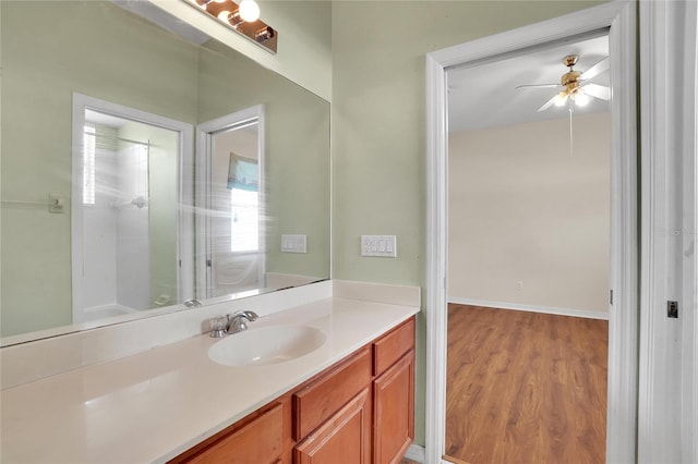 bathroom featuring hardwood / wood-style flooring, vanity, and ceiling fan