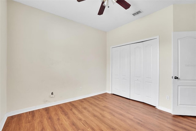 unfurnished bedroom with a closet, ceiling fan, and hardwood / wood-style floors