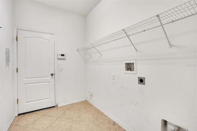 clothes washing area featuring hookup for an electric dryer, hookup for a gas dryer, hookup for a washing machine, and light tile patterned floors